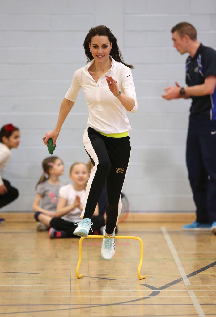 Kate running towards hurdle in sports hall