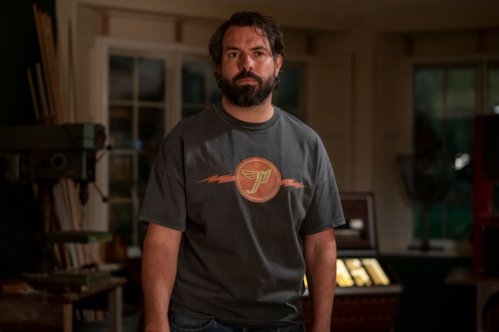 man standing in dimly-lit house