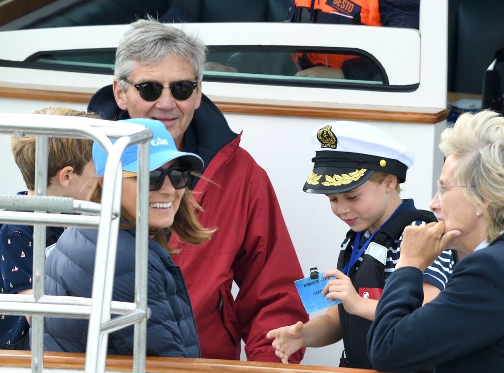 Carole and Michael smile whilst taking care of Prince George