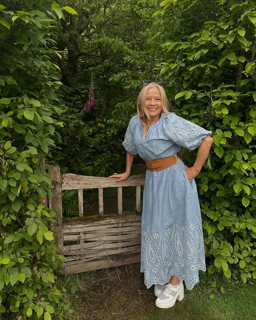 woman in denim dress with wide belt 