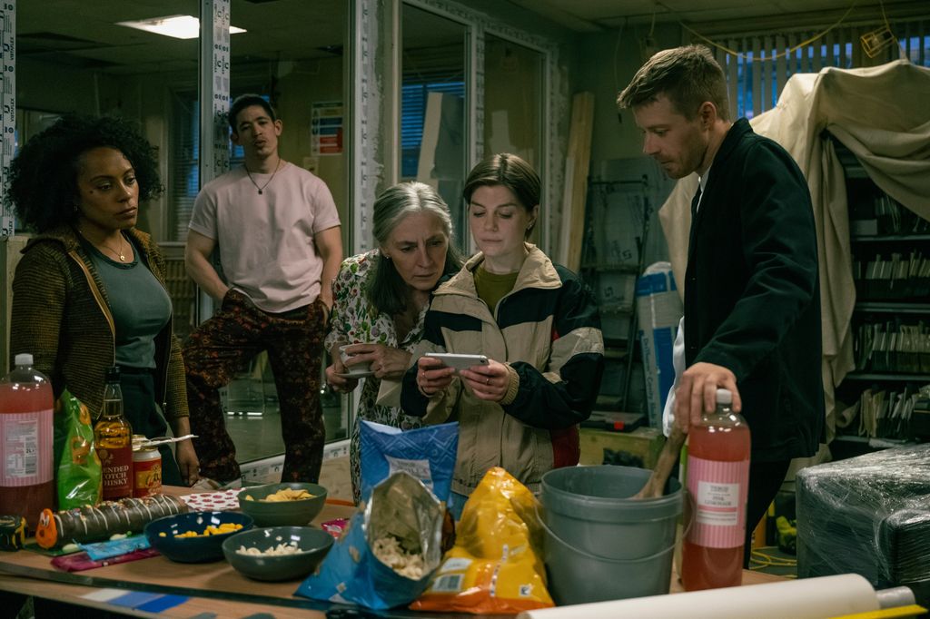 group of people in office looking at phone