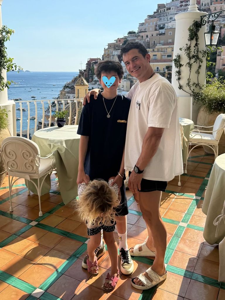 Orlando Bloom poses on a terrace of a Portofino restaurant with son Flynn and daughter Daisy, shared on Instagram