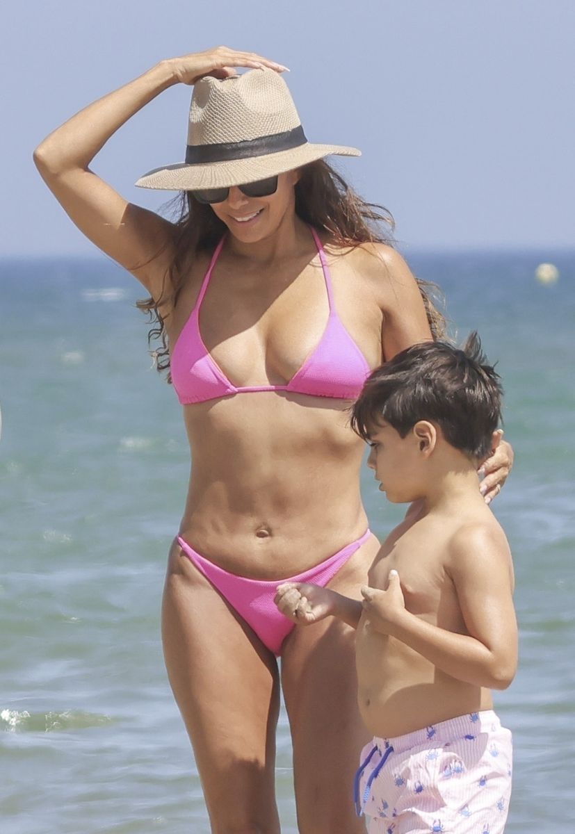 Eva Longoria in a pink bikini with her son at the beach in Spain