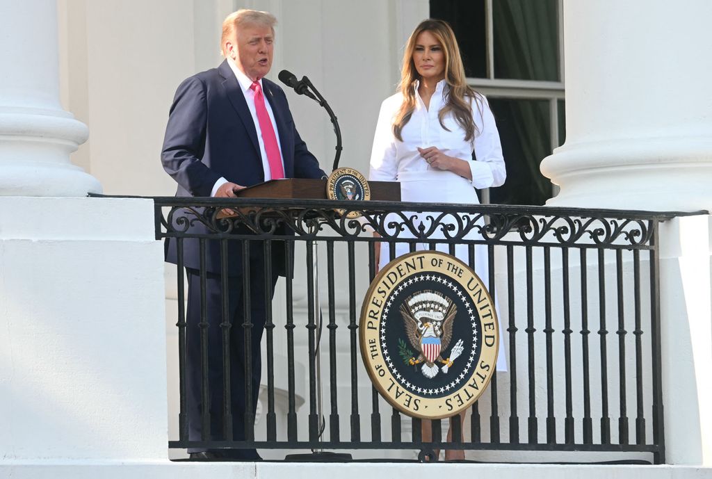Donald Trump speaks at the Military Family Picnic on the South Lawn of the White House in Washington, DC, on July 4, 2025 as Melania Trump looks on