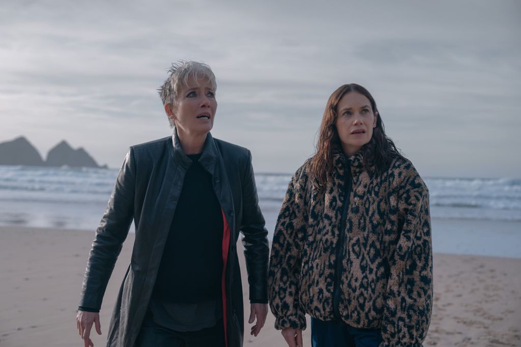 two women standing on beach