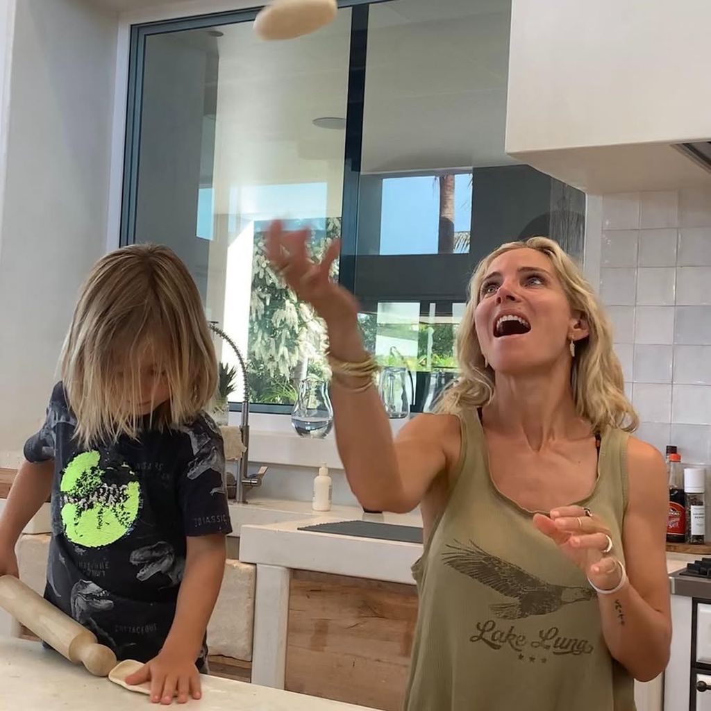 Elsa Pataky and her son throwing dough in the air while baking in their kitchen