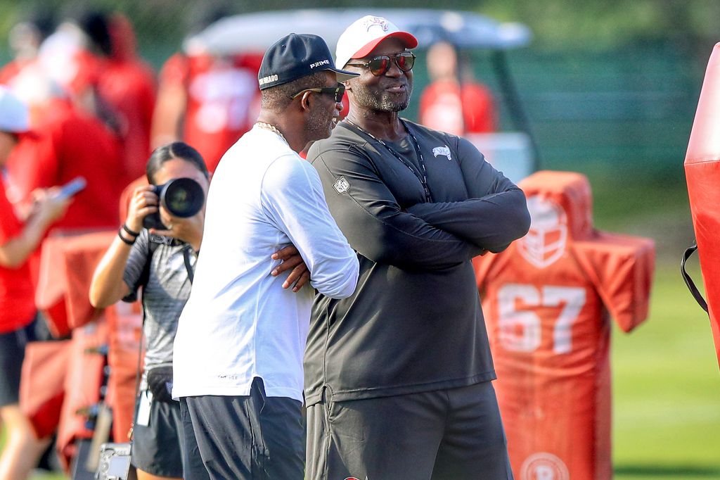 University of Colorado Head Coach Deion Sanders shares a laugh with Tampa Bay Buccaneers Head Coach Todd Bowles