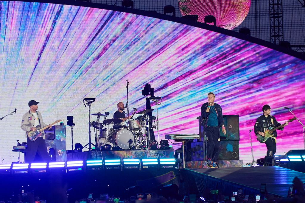 Jonny Buckland, Will Champion, Chris Martin and Guy Berryman of Coldplay perform at Rogers Stadium on July 07, 2025 