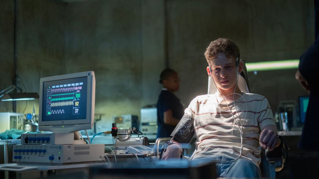 Joe Freeman in character in The Institute hooked up to machines