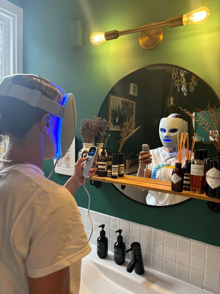 Lucy Bronze looking in the mirror in the bathroom wearing a face mask