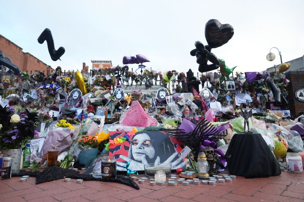 Floral tributes left at the Black Sabbath Bridge bench on Broad Street in Birmingham in memory of Black Sabbath frontman Ozzy Osbourne, ahead of his body brought back to his home city for a procession following his death last week aged 76. Picture date: Wednesday July 30, 2025. (Photo by Joe Giddens/PA Images via Getty Images)