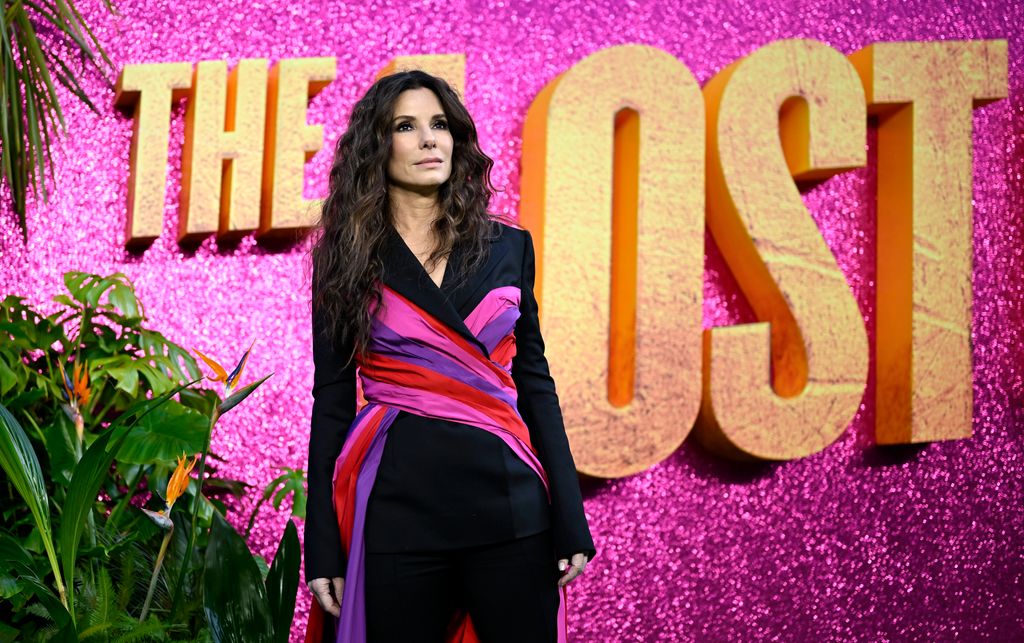 Sandra Bullock in black dress with pink and purple lining