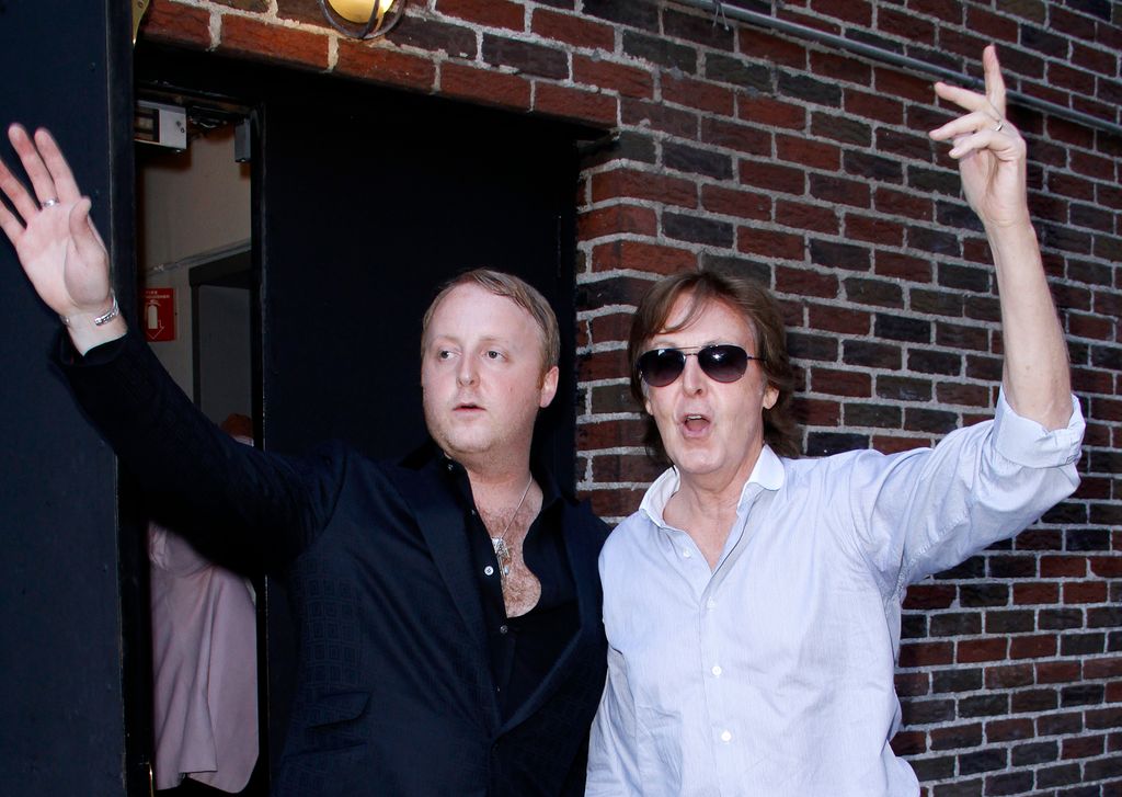 photo of james mccartney and paul mccartney with their arms in the air