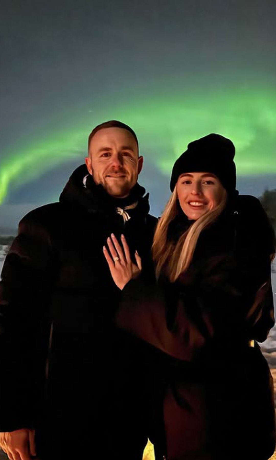Chloe Kelly and her fiance in front of the Northern Lights