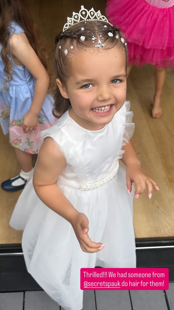 Gigi in white dress and tiara