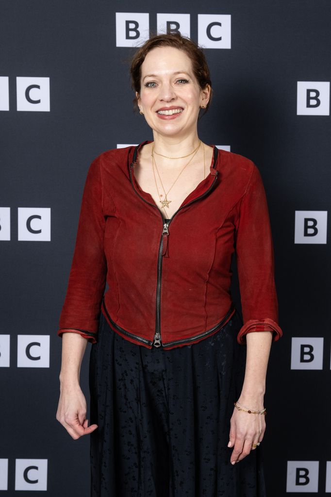 Katherine Parkinson in a red fleece in front of a grey background