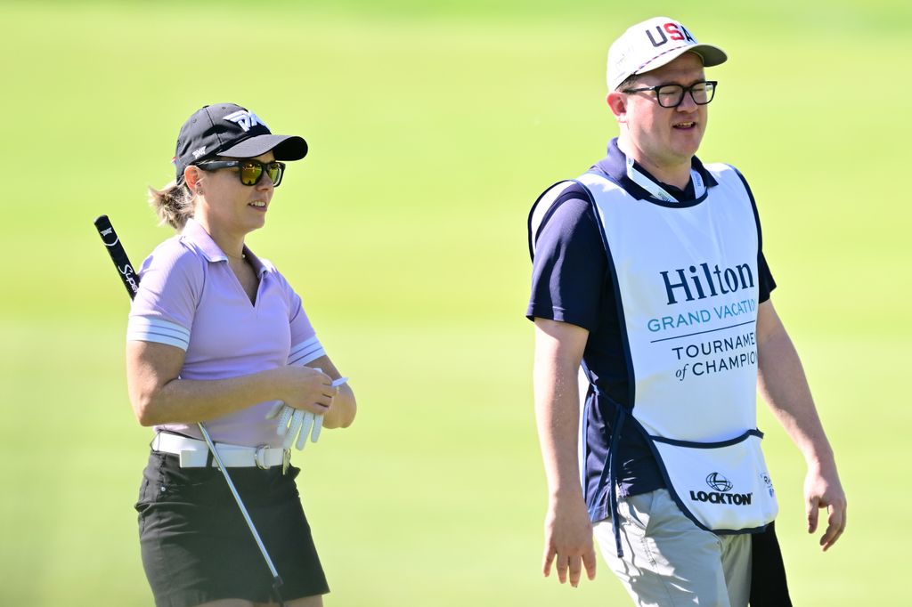 Dylan Dreyer walks on the 12th green with her caddie, husband Brian, during the first round of the Hilton Grand Vacations Tournament