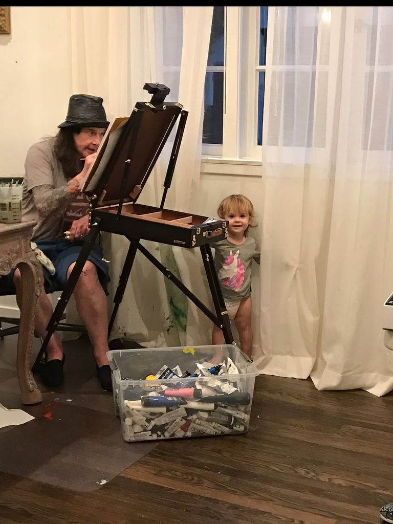 Ozzy Osbourne paints at his easel