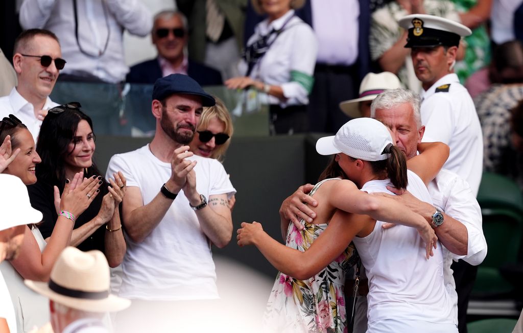 Courteney Cox and Johnny McDaid (left) celebrate with Iga Swiatek following the Ladies' Singles Final on day thirteen of the 2025 Wimbledon Championships 