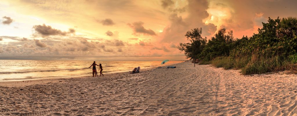 Sunset over the white sand at Delnor Wiggins State Park in Naples, Florida.