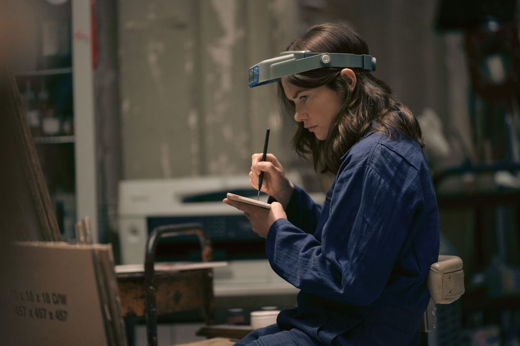 woman in blue jacket in workshop
