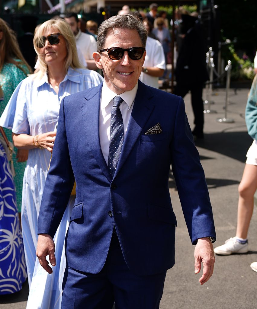 rob brydon at wimbledon in navy suit 