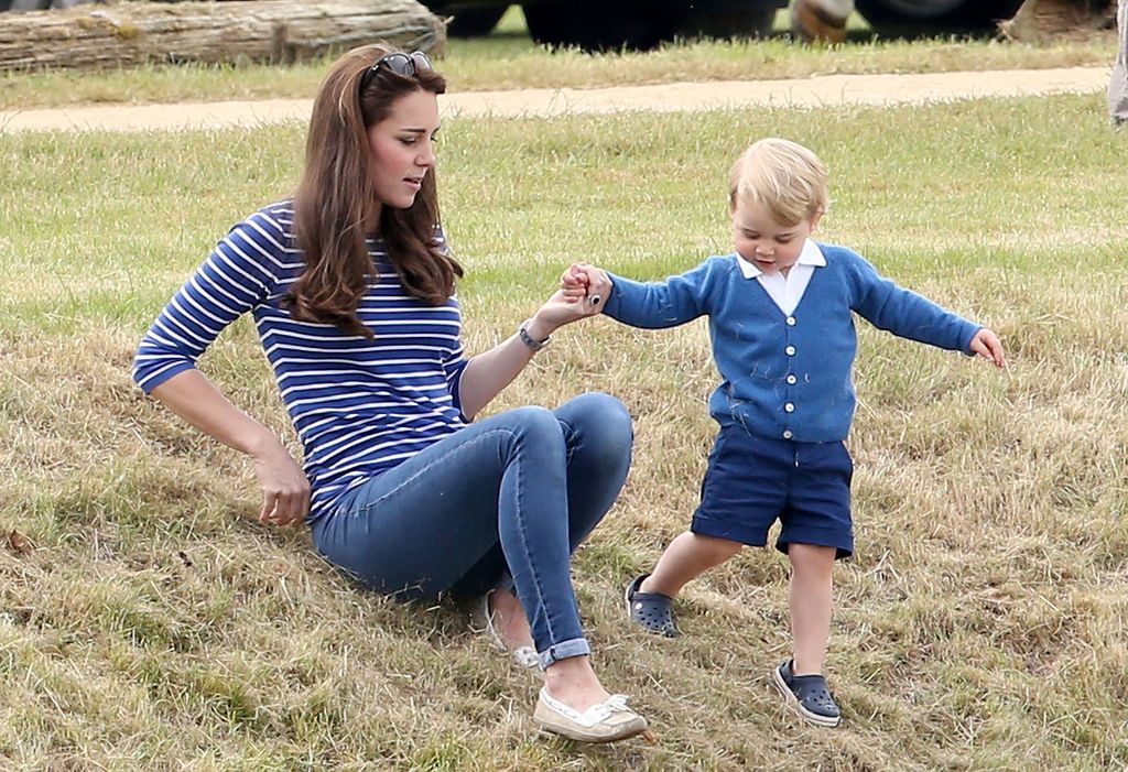 Kate helping tiny Prince George down a hill