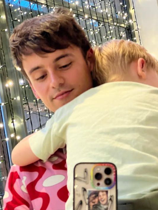 Tom Daley holding his son Robbie