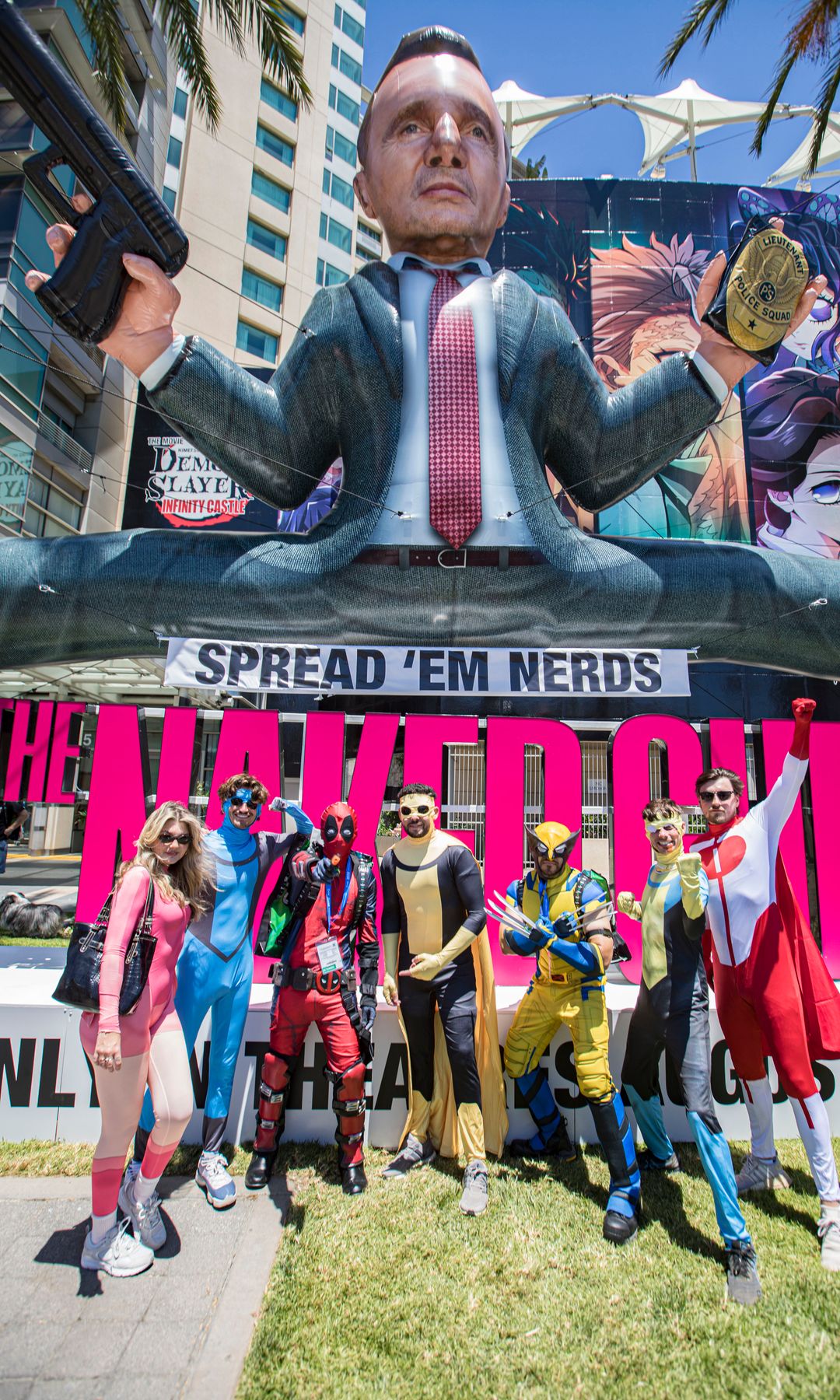 A group of cosplayers poses with the 'Naked Gun 2' display at Comic-Con International in San Diego, California. 