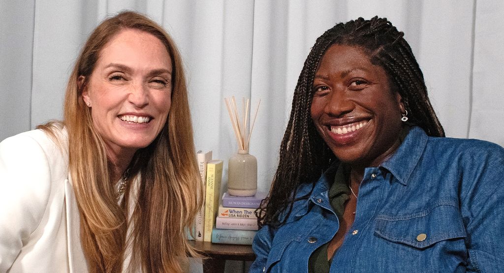 two midlife women smiling widely