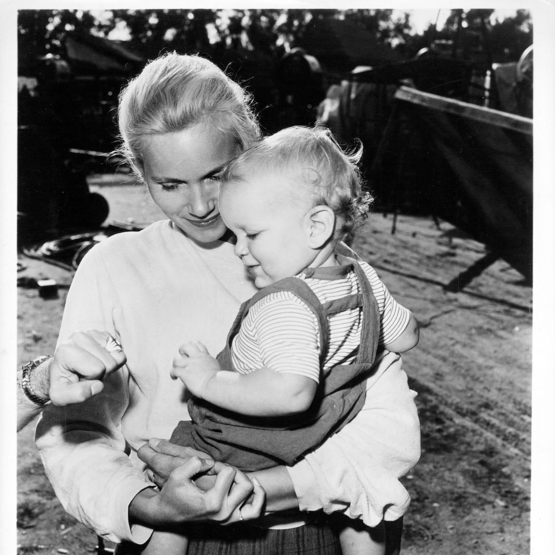 Eva Marie Saint holding son Darrell in publicity portrait for the film 'Raintree County', 1957