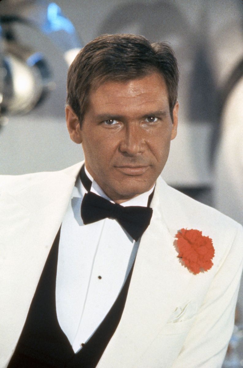 Harrison Ford on the set of "Indiana Jones and the Temple of Doom" wearing a similar look.