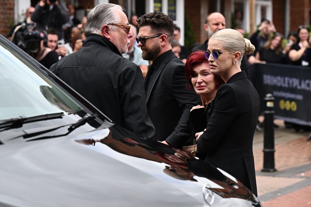 Jack Osbourne, Sharon Osbourne and Kelly Osbourne arrive to view tributes to the late Ozzy Osbourne from fans as his funeral cortege travels through his home city of Birmingham on July 30, 2025 