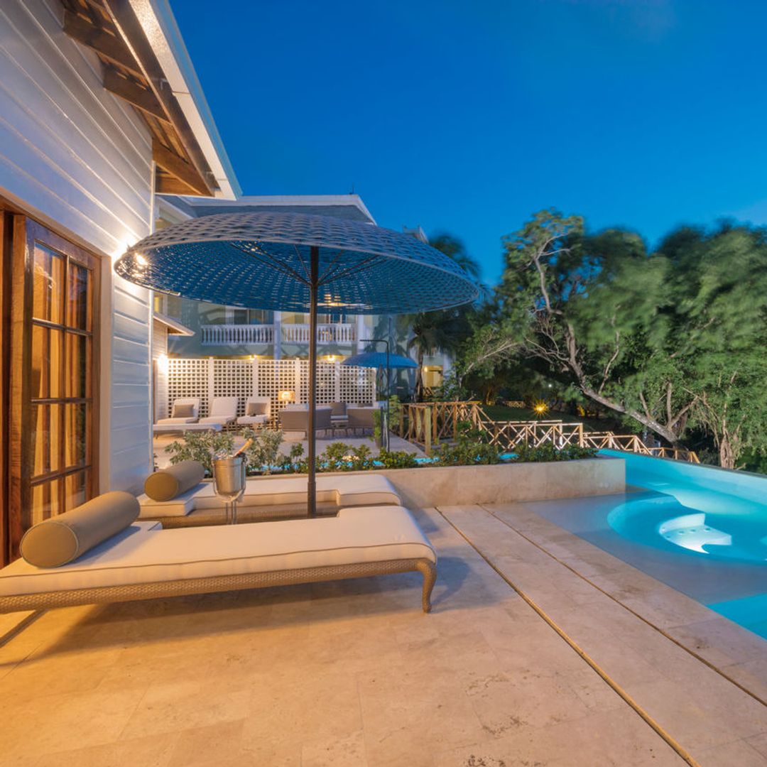 Hotel outdoor terrace with pool and sun loungers in Jamaica