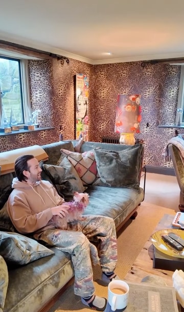 man on sofa in leopard print living room