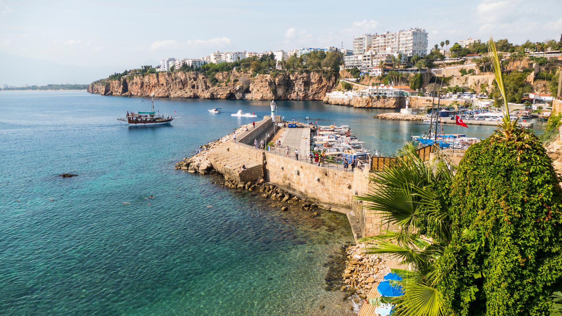 Shot of the Harbor and Konyaali Beach with boats sailing