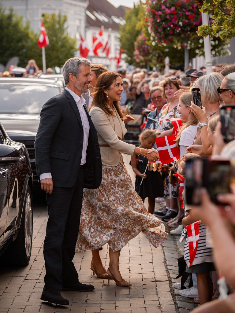 King Frederik and Queen Mary greeting crowds in Grasten