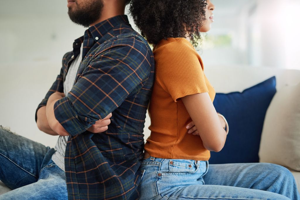 couple back to back with arms crossed