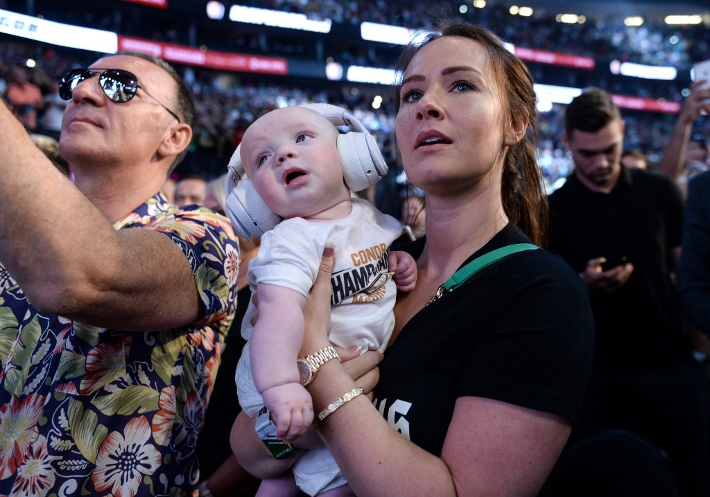 LAS VEGAS, NV - AUGUST 25: Dee Devlin holds Conor McGregor Jr. and watches as Conor McGregor pose on the scale during his official weigh-in at T-Mobile Arena on August 25, 2017 in Las Vegas, Nevada. McGregor will meet boxer Floyd Mayweather Jr. in a super welterweight boxing match at T-Mobile Arena on August 26. (Photo by Brandon Magnus/Zuffa LLC/Zuffa LLC via Getty Images)