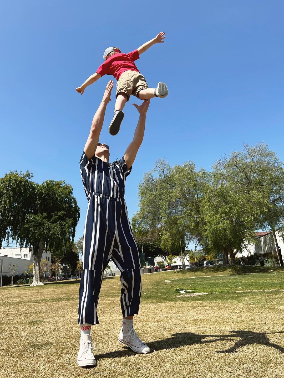 father throwing child into air