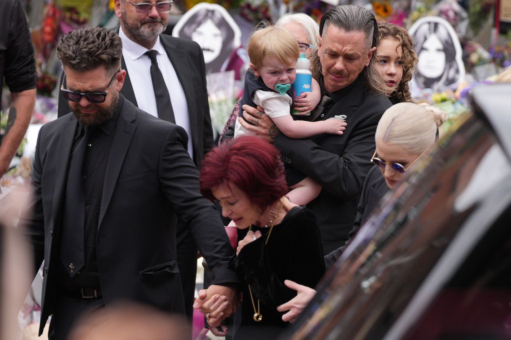 Jack Osbourne, Sharon Osbourne, Kelly Osbourne and family members stop to view tributes to the late Ozzy Osbourne from fans at Black Sabbath Bench and Bridge 
