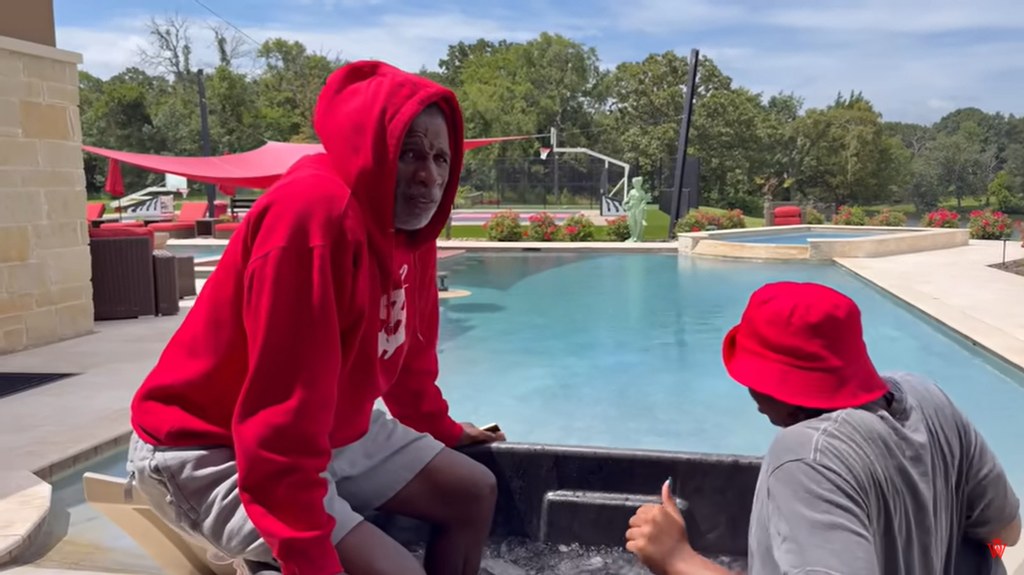 Deion Sanders sits in an ice bath