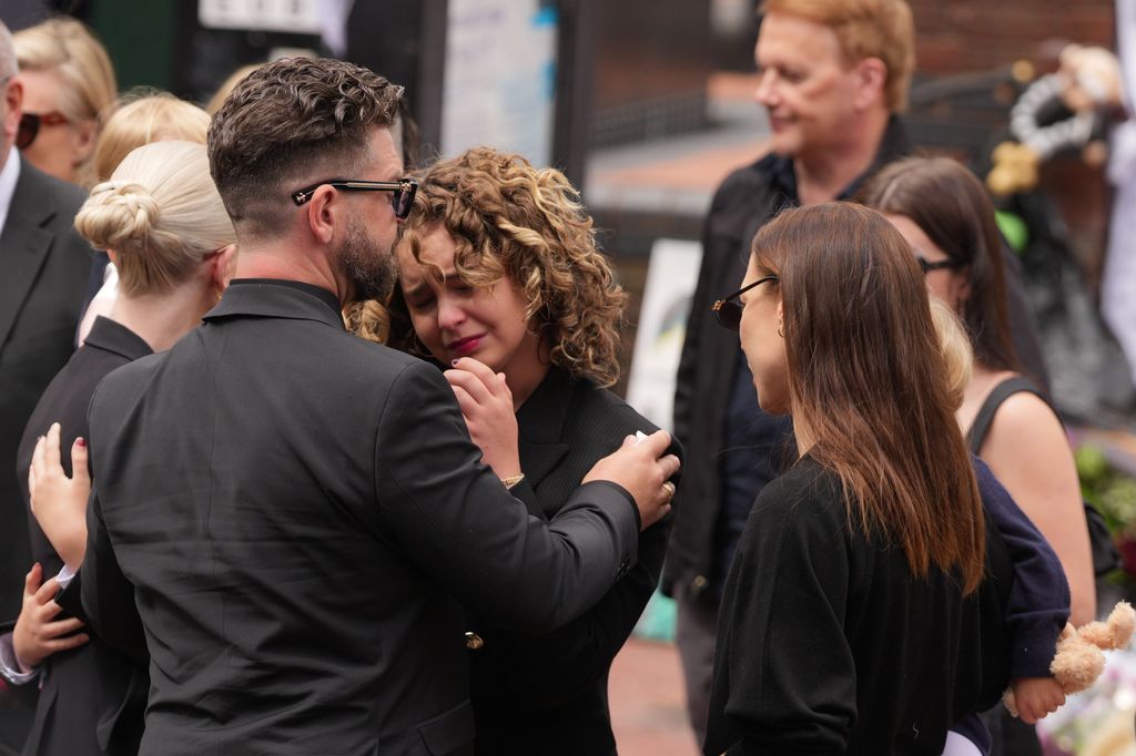 Jack Osbourne and Pearl Osbourne stopping to view tributes to the late Ozzy Osbourne from fans at Black Sabbath Bench and Bridge as his funeral cortege travels through his home city of Birmingham on July 30, 2025 in Birmingham, England. The Black Sabbath frontman passed away on July 22nd at the age of 76. His death occurred just a little over two weeks after his final live performance at the 'Back to the Beginning' concert in his hometown of Birmingham. (Photo by Christopher Furlong/Getty Images)