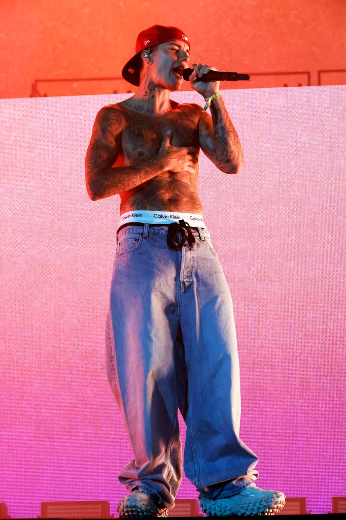 Justin Bieber performing shirtless in a pair of baggy jeans