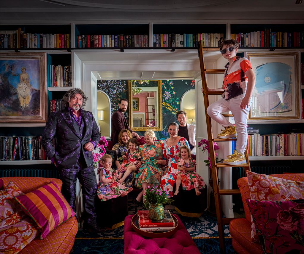 Laurence Llewelyn-Bowen and wife Jackie with their children and grandchildrne in library of Cotswolds home