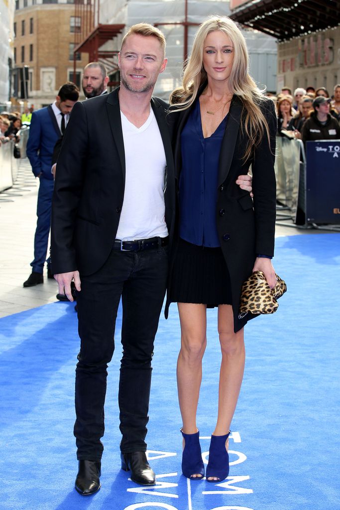 Ronan Keating in a black suit and Storm in a blazer in the sunshine