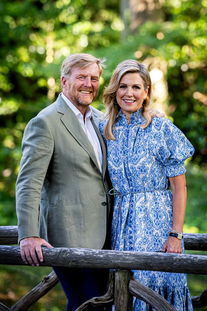 King Willem-Alexander of The Netherlands and Queen Maxima of The Netherlands pose for the media outside in front of greenery