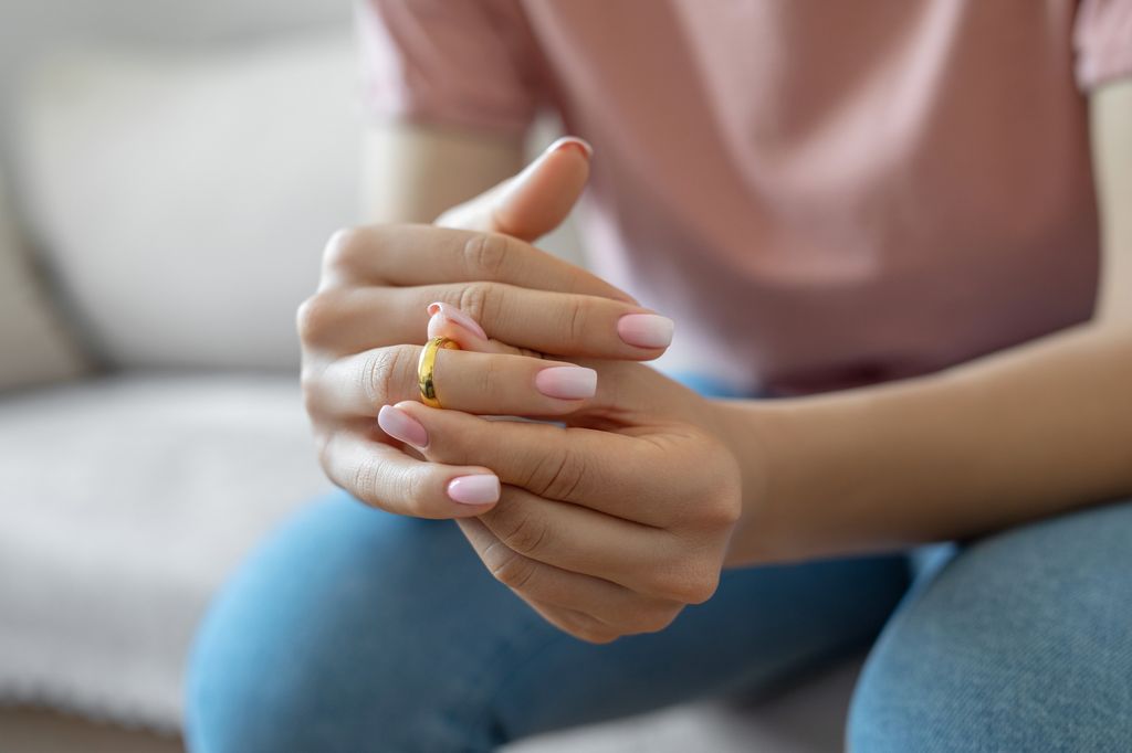 Woman taking off wedding ring
