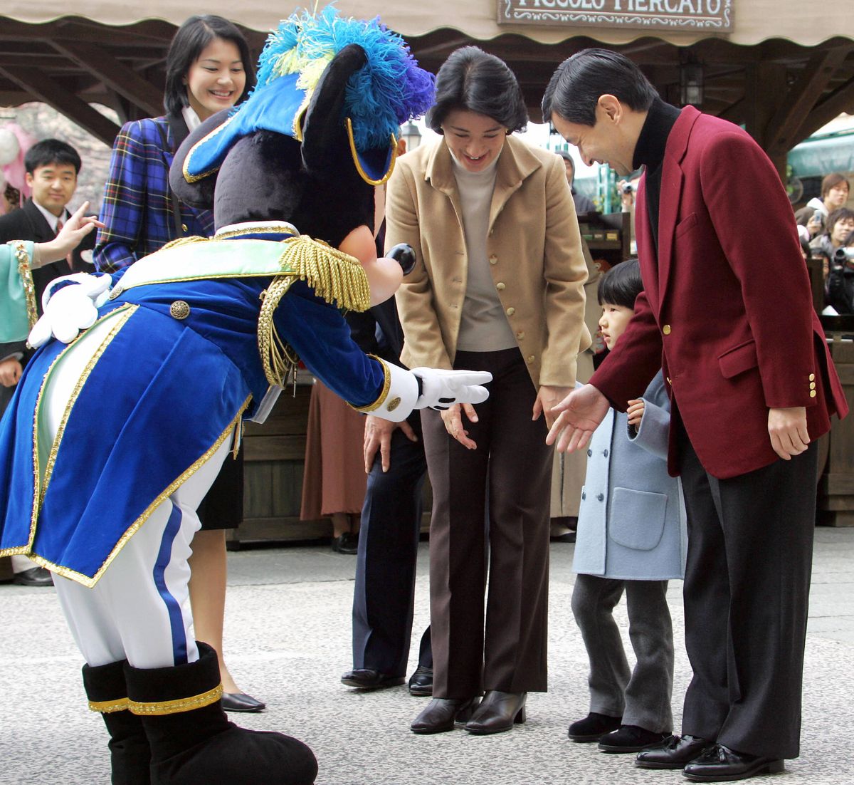 URAYASU, JAPAN:  Japanese Princess Aiko (2nd R), accompanied by her parents Crown Prince Naruhito (R) and Crown Princess Masako (3rd R), is welcomed by Disney charactor Mickey Mouse upon arrival at Tokyo DisneySea in Urayasu, suburban of Tokyo, 13 March 2006. Four-year-old Japanese Princess Aiko, the only child of the crown prince, toured Tokyo Disneyland, with her parents hoping to give her some trappings of a normal childhood.  AFP PHOTO/Kazuhiro NOGI/POOL  (Photo credit should read KAZUHIRO NOGI/AFP via Getty Images)