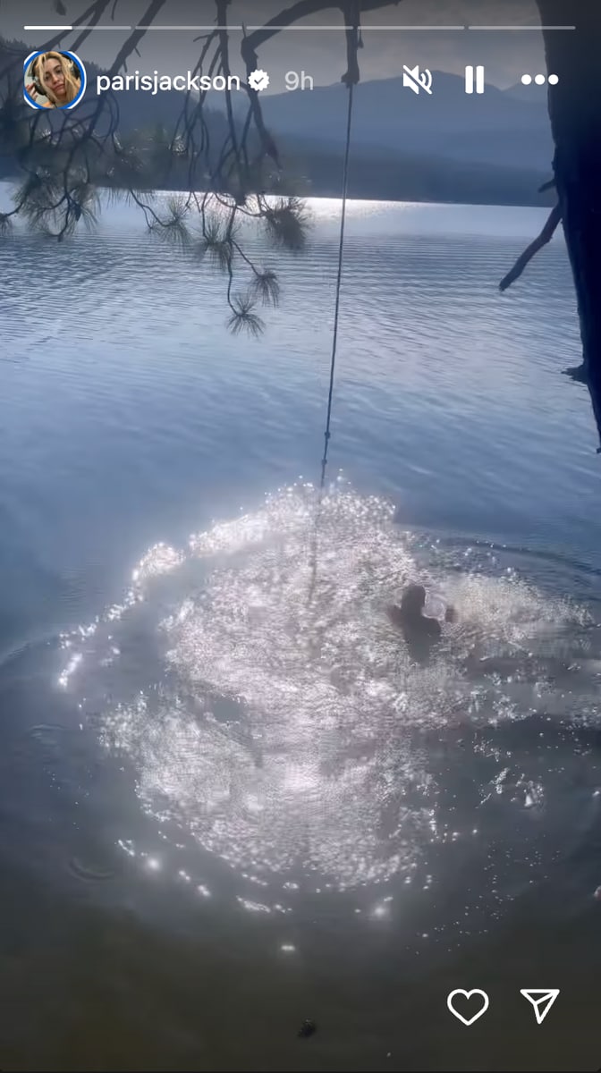 Another photo shows Paris standing waist-deep in the lake.
